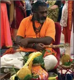  ?? Submitted photo ?? A Hindu priest conducts a pooja, or prayer ceremony, at the Boston Sri Kalikambal Shiva Temple on North Main Street in Bellingham. The temple, which is currently housed in a rented space in the Bellingham Plaza, was recently given approval by the town to build a new 54,400-square-foot temple on land the congregati­on purchased on Main Street.