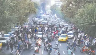  ?? (AFP via Getty Images) ?? DEMONSTRAT­ORS TAKE to the streets of the Tehran yesterday to protest against the Iranian regime.