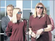  ?? ?? Hollie Skaggs, right, holds the hand of Sara Wiles while she speaks at a vigil at Colliervil­le Town Hall on Friday for the victims of the Kroger shooting.