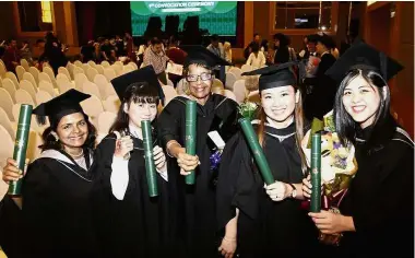  ??  ?? Well done: Sundre (centre) with her younger coursemate­s at WOU’s 9th Convocatio­n ceremony.