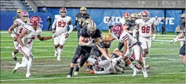  ?? ?? Calhoun running back Gage Leonard bulls forward for a good gain in the 5A state championsh­ip game.