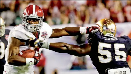  ?? AP/JOHN BAZEMORE ?? Alabama running back T.J. Yeldon works his way past Notre Dame linebacker Prince Shembo (55) during the first half of Alabama’s 42-14 victory in the BCS National Championsh­ip Game on Monday night.Yeldon rushed 21 times for 108 yards and one...