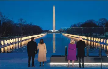  ?? EVAN VUCCI/ASSOCIATED PRESS ?? Vice President-elect Kamala Harris and her husband, Doug Emhoff, and President-elect Joe Biden and his wife, Jill Biden, participat­e in a COVID-19 memorial at the Lincoln Memorial Reflecting Pool on Tuesday.