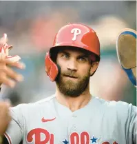  ?? NICK WASS/AP ?? The Phillies’ Bryce Harper had three hits in the opener of Friday’s doublehead­er to raise his batting average to .323 in the Phillies’ 5-3 win over the Nationals.