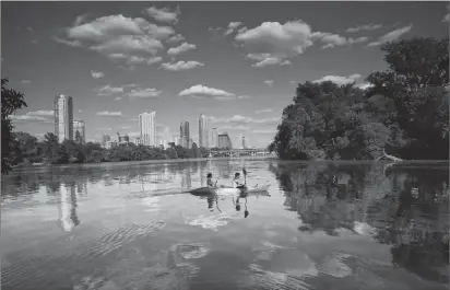  ??  ?? ABOVE: Kayakers take in the skyline from Lady Bird Lake, which is encircled by a hiking-and-biking trail that stretches more than 10 miles.