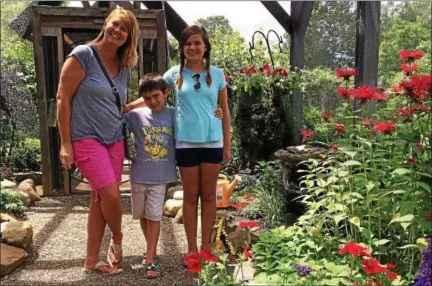  ?? CAROL HARPER — THE MORNING JOURNAL ?? Maureen Shildwacht­er and her children Charlie Shildwacht­er, 7, and Ava Shildwacht­er, 11, from Avon Lake, delighted in watching the butterflie­s July 1, in a butterfly house at Miller Nature Preserve at 2739 Center Road in Avon.