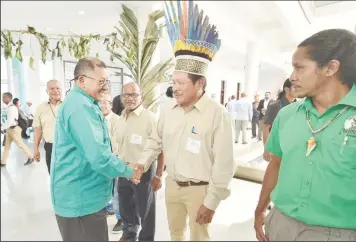  ??  ?? Vice President and Minister of Indigenous Peoples’ Affairs, Sydney Allicock greets Toshaos upon his arrival at the Arthur Chung Conference Centre, Liliendaal. (Ministry of the Presidency photo)