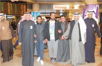  ??  ?? KUWAIT: Four Kuwaitis who were arrested several days ago in Iran are welcomed at Kuwait airport by family and friends and senior officials yesterday. — KUNA