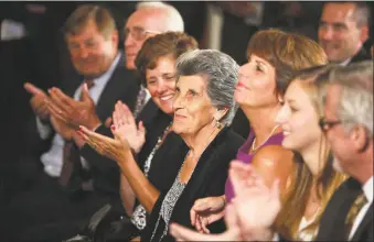  ?? Chip Somodevill­a / Getty Images ?? Marciella Auriemma, center, mother of Huskies women's basketball head coach Geno Auriemma, sits in the front row to watch her son's team being honored by President Barack Obama in the East Room of the White House on July 31, 2013. Obama hosted the team after it defeated the University of Louisville to win its eighth national championsh­ip. At top, Auriemma speaks during The Celebratio­n of Life for Kobe & Gianna Bryant at Staples Center on Feb. 24 in Los Angeles.