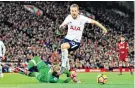  ??  ?? Harry Kane wins his first spot-kick chance after Loris Karius’ challenge