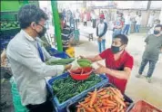  ??  ?? People maintain distance outside a state food supply department in Guwahati on Wednesday. ANI