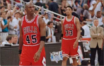  ?? AP Photo/Robert Baker ?? In this 1995 file photo, Chicago Bulls guard Michael Jordan (45) and forward Scottie Pippen (33) walk back to the bench during a timeout in the closing seconds of an NBA basketball playoff game in Orlando.