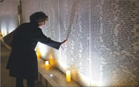  ?? (AP/Lisa Leutner) ?? A relative of victims of the Nazis visits the Shoah Wall of Names Memorial on Tuesday after the inaugurati­on ceremony in Vienna, Austria.