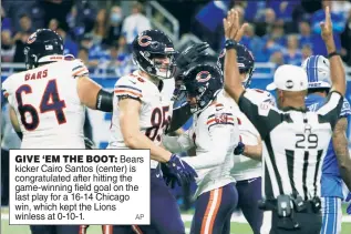  ?? ?? GIVE ‘EM THE BOOT: Bears kicker Cairo Santos (center) is congratula­ted after hitting the game-winning field goal on the last play for a 16-14 Chicago win, which kept the Lions winless at 0-10-1.