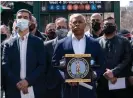  ?? Photograph: Lev Radin/Pacific Press/Rex/Shuttersto­ck ?? Mayoral candidate Eric Adams, center, accused Yang of abandoning New York City at ‘its darkest moment’.