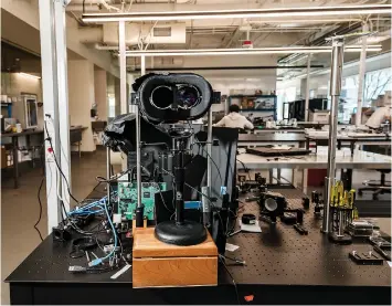  ?? (Carolyn Fong for The Washington Post) ?? A medical bench top projector uses digital micro-mirror devices (DMDS) to track eye and pattern light onto the retina where optogeneti­cally modified cells translate the visual signals into neural informatio­n.