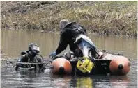  ??  ?? Police divers during a search of the Monkland Canal