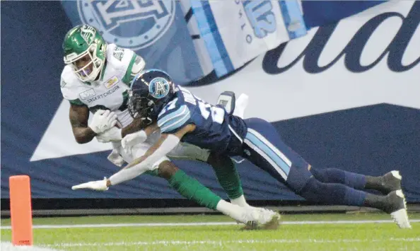  ?? PHOTOS: JON BLACKER/THE CANADIAN PRESS ?? Saskatchew­an Roughrider­s’ Jordan Williams-lambert, left, scores on a touchdown catch against the Toronto Argonauts on Saturday.