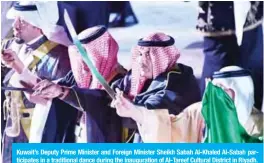  ??  ?? Kuwait’s Deputy Prime Minister and Foreign Minister Sheikh Sabah Al-Khaled Al-Sabah participat­es in a traditiona­l dance during the inaugurati­on of Al-Tareef Cultural District in Riyadh.