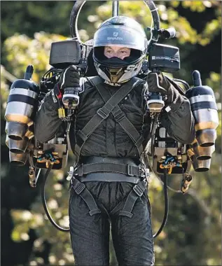  ?? DAVID MAYMAN, Michael Cole Corbis ?? CEO of JetPack Aviation, demonstrat­es one of his devices July 14. Recent reports of someone with a jet pack near LAX have caused a buzz in the aviation community.