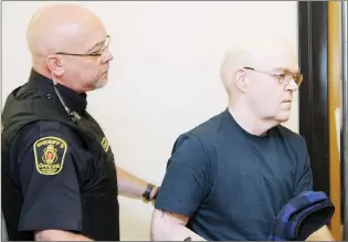  ?? TARA BRADBURY/THE TELEGRAM ?? Rodney Parsons (right), 51, is taken into custody by a sheriff’s officer at provincial court in St. John’s Tuesday morning after he was sentenced to jail time for luring a child via the internet.