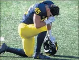  ??  ?? Michigan’s Adam Shibley takes a knee after the Wolverines lost to the Spartans on Saturday at Michigan Stadium.