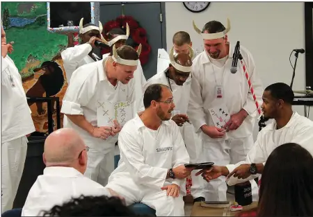  ?? Arkansas Democrat-Gazette/FRANCISCA JONES ?? Pathway to Freedom program members put on a morality play for other inmates and their families during the family Christmas banquet. Unlike events at other times of the year, this is one where inmates in Pathway to Freedom can gather with loved ones, a...