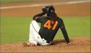  ?? LACHLAN CUNNINGHAM/GETTY IMAGES ?? Giants pitcher Johnny Cueto sits on the pitching mound after being hit by a throw from catcher Tyler Heineman in the sixth inning against the San Diego Padres on Saturday in San Francisco.