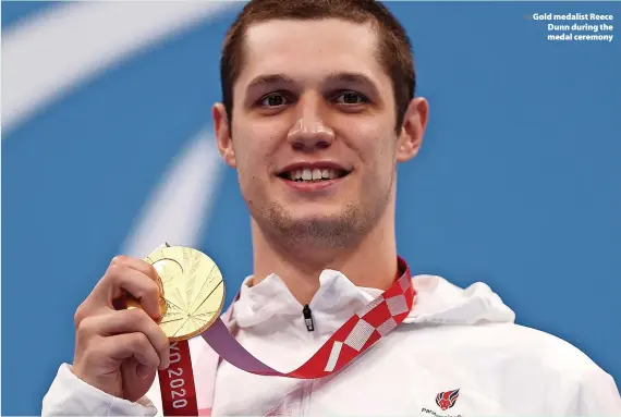  ?? Dean Mouhtaropo­ulos ?? > Gold medalist Reece Dunn during the medal ceremony