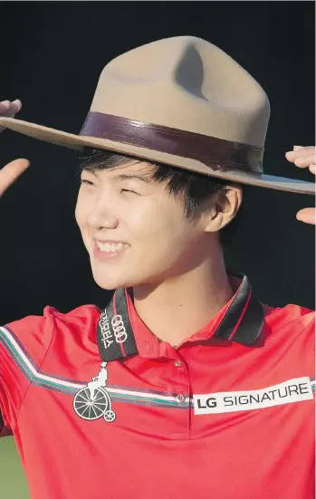  ?? ADRIAN WYLD/THE CANADIAN PRESS ?? Sung Hyun Park of South Korea tries on a Mountie hat after winning the 2017 Canadian Pacific Women’s Open in Ottawa on Sunday. Brooke Henderson, the top Canadian, tied for 12th.