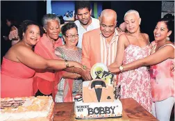  ?? PHOTOS BY ASHLEY ANGUIN ?? Robert Pickersgil­l cuts his 25th anniversar­y cake with his family (from left): his niece Kira, his sister Sonia, his sister-in-law Fae, his nephew Omar Casserly, his wife Suzanne Constantin­e and niece Karen Pickersgil­l.