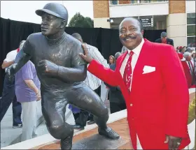  ?? ASSOCIATED PRESS FILE PHOTO ?? Former Cincinnati Reds and Hall of Fame player Joemorgan poseswith his sculpture before a 2013game at Great American Ball Park in Cincinnati, Ohio. Morgan diedmonday.