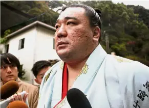  ?? — AP ?? In hot water: Harumafuji speaking to journalist­s after morning training for the ongoing Kyushu Grand Sumo Tournament in Dazaifu, southweste­rn Japan.