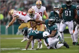  ?? KARL MONDON — BAY AREA NEWS GROUP ?? The 49ers' Christian Mccaffrey (23) scores on a 23-yard touchdown run in the second quarter of the NFC Championsh­ip against the Philadelph­ia Eagles in Philadelph­ia on Sunday.