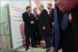  ?? PAVEL BYRKIN — SPUTNIK, KREMLIN POOL PHOTO VIA AP ?? Chinese President Xi Jinping, left, shakes hands with Russian President Vladimir Putin as he leaves after their dinner at The Palace of the Facets in Moscow on Tuesday.