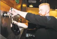  ?? Ned Gerard / Hearst Connecticu­t Media ?? Jeff Janosko, operations manager, fills a growler of beer at Veracious Brewing in Monroe on Thursday.
