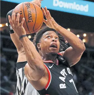  ?? KEVIN C. COX GETTY IMAGES ?? Kyle Lowry of the Toronto Raptors drives to the basket against DeAndre’ Bembry of the Atlanta Hawks during Thursday’s game at State Farm Arena. The Raptors beat the Hawks 119-101.