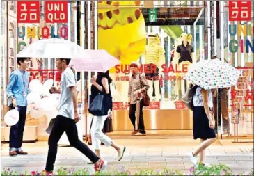  ?? KAZUHIRO NOGI/AFP ?? Uniqlo stores will start charging customers for shopping bags in September.