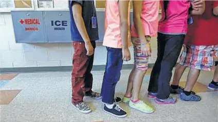  ?? Eric Gay /Associated Press file ?? Detained children line up at the Karnes County Residentia­l Center. Homeland Security officials may use the site for single adults.