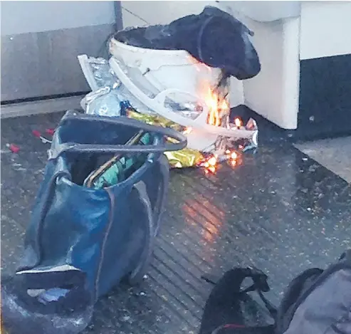  ?? AFP PHOTO / HANDOUT ?? A picture obtained from the twitter user @RRigs shows a white container burning inside a London Undergroun­d tube carriage on Friday. British police are treating the incident as an act of terrorism.