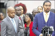  ?? MIC SMITH/AP ?? Judy Scott, center, Walter Scott’s mother, is comforted by her son Rodney Scott at a press conference Dec. 5 after the mistrial was declared.