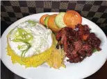  ??  ?? The Philippine breakfast called tosilog includes sweet pork, garlic rice and a fried egg at Sari-Sari Filipino Restaurant Market & Bakery.