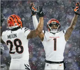  ?? JOSHUA BESSEX — THE ASSOCIATED PRESS ?? Bengals wide receiver Ja’Marr Chase (1) and running back Joe Mixon (28) motion for a touchdown against the Bills during the third quarter last week in Orchard Park, N.Y.