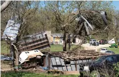  ?? (Evert Nelson/The Topeka Capital-Journal via AP) ?? Metal sidings are thrown up in trees on Ethan Steenbach’s property Tuesday morning in Overbrook, Kan., following a tornado that hit the area.