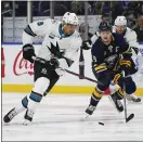  ?? JEFFREY T. BARNES — THE ASSOCIATED PRESS ?? The Sharks’ Evander Kane, in his return to Buffalo on Tuesday night, chases the Sabres’ Jack Eichel, right, to the puck.