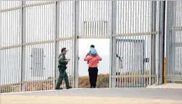  ?? Gary Coronado Los Angeles Times ?? AT THE U.S.-MEXICO border, a family is escorted back to San Diego after paying a visit to Friendship Park in Tijuana. Decades ago, crossing was cavalier.