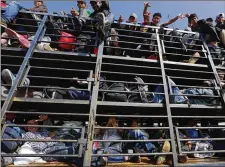  ?? MARCO UGARTE/ AP ?? Central American migrants get a ride on a truck in Celaya, Mexico, on Sunday. Local Mexican officials were helping thousands of migrants find rides on their journey toward the U.S. border.