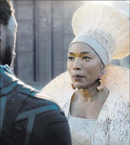  ?? Disney Marvel Studios The Associated Press ?? Chadwick Boseman and Angela Bassett in a scene from “Black Panther,” which features a number of powerful female leads.