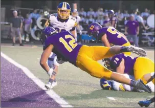  ?? The Sentinel-Record/Grace Brown ?? FLYING COBRA: Fountain Lake senior running back Colson Simpson (12) dives into the end zone to score a touchdown in the first half of last Friday night’s win over Lakeside while Ram senior Reece Turner (20) looks on.