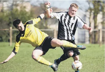  ??  ?? Lift off for Midgley’s Greg Spink under pressure from Stump Cross’s Adam Barlow
Pictures: Bruce Fitzgerald